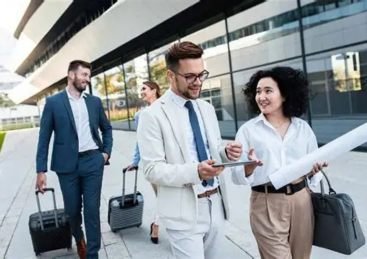 Business travellers walking with luggage
